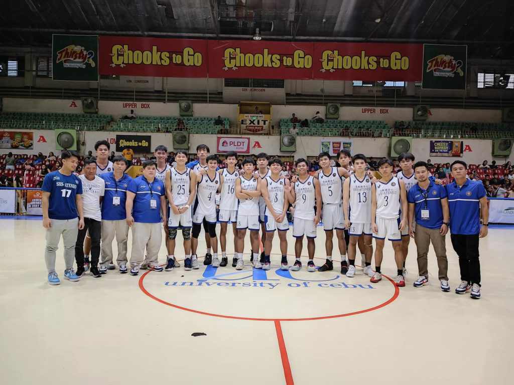 The Magis Eagles coaches and players pose for a photo after a Cesafi game.