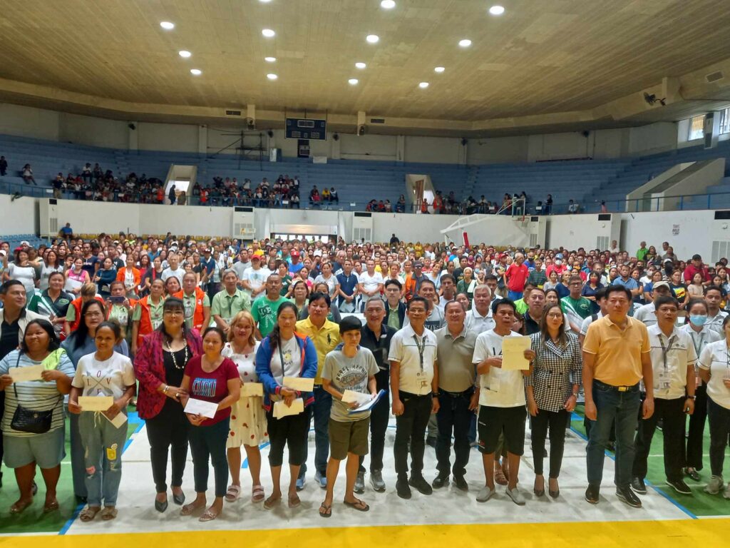 Super Typhoon Odette-affected families gather at the Mandaue City Sports and Cultural Complex on Monday, Oct. 16, to receive the cash aid from the National Housing Authority. 