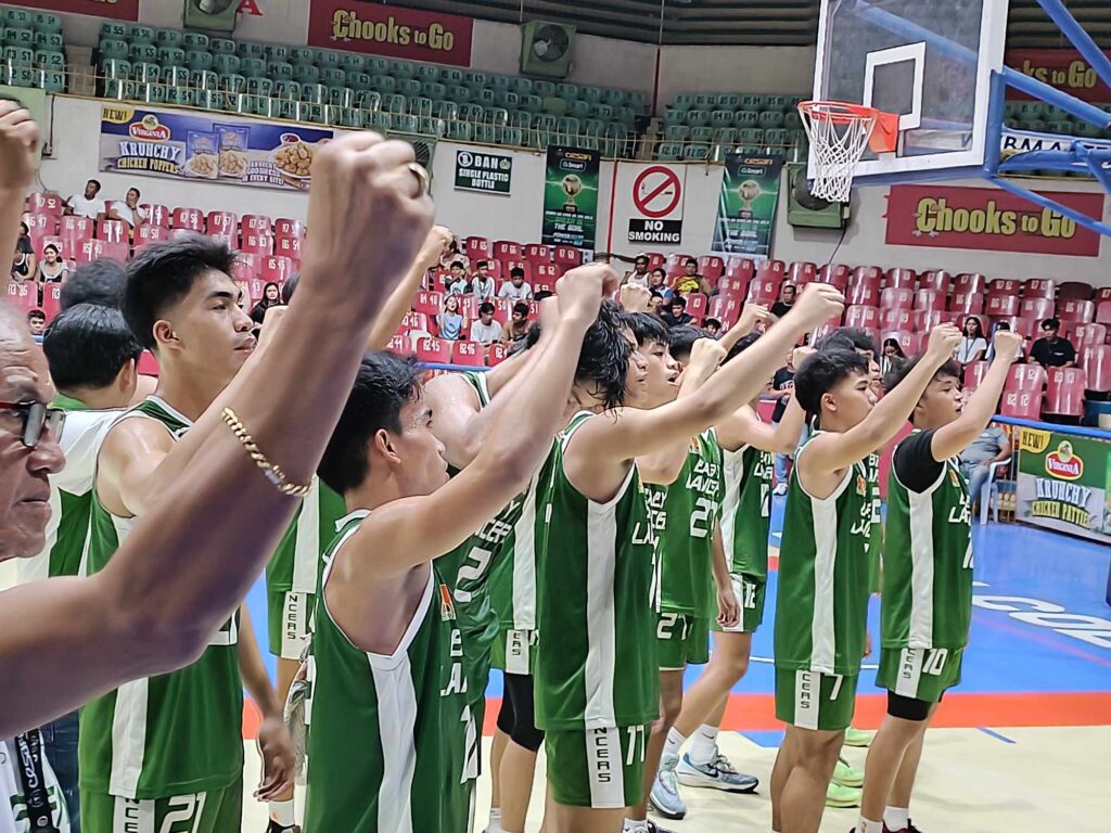 The UV Baby Green Lancers clinch their fists while singing their school hymn after their win in the Cesafi on Thursday, Oct. 19. |