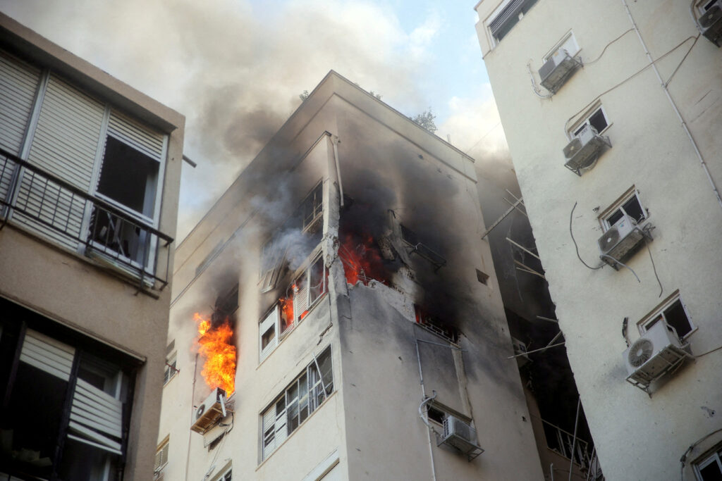 A building is ablaze following rocket attacks from the Gaza Strip, in Tel Aviv, Israel October 7, 2023. REUTERS