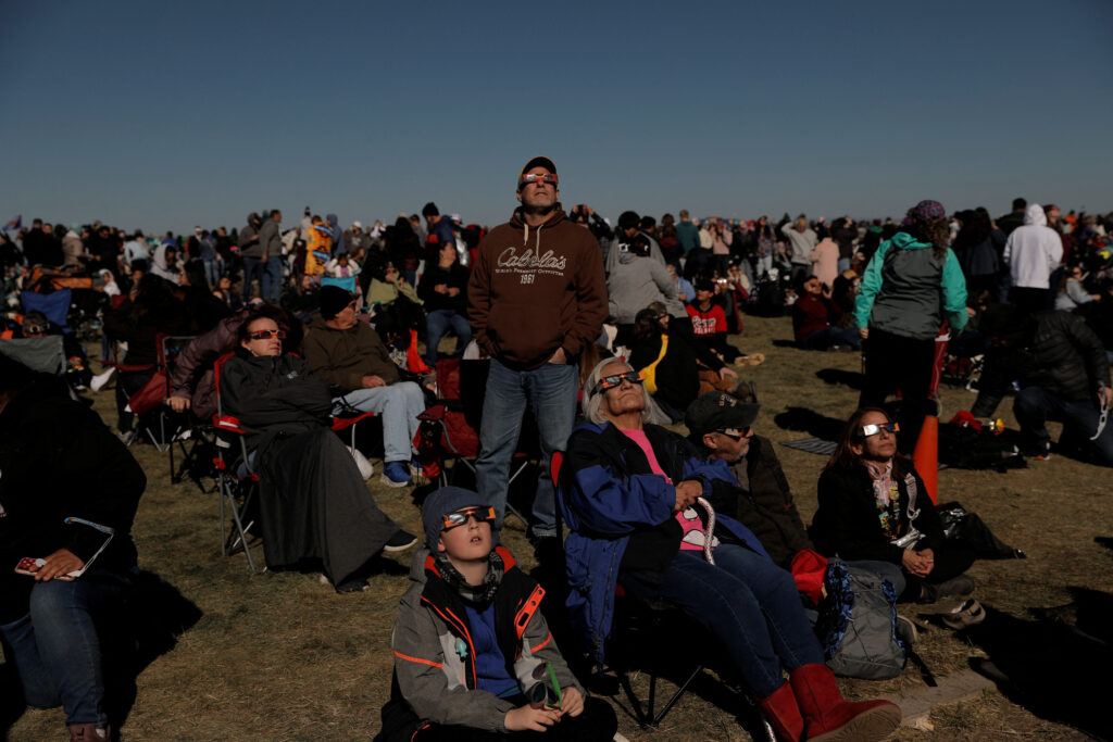 People gather to watch the annular solar eclipse at the Albuquerque International Balloon Fiesta in Albuquerque, New Mexico, U.S., October 14, 2023. REUTERS/Adria Malcolm