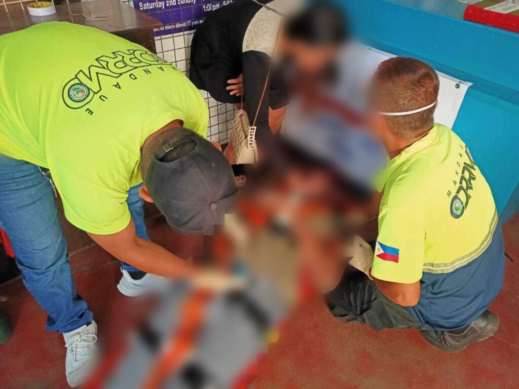 Murder charges filed against 6 Chinese nationals accused of mauling Nigerian, who died in hospital. In photo are personnel of the Mandaue City Disaster Risk Reduction Management Office prepare to take the Nigerian to the hospital. | MCPO photo
