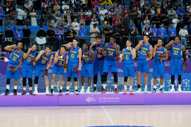 Gilas Pilipinas members celebrate with their gold medals after defeating Jordan in their men’s basketball gold medal at the 19th Asian Games in Hangzhou, China, Friday, Oct. 6, 2023. (AP Photo/Lee Jin-man)