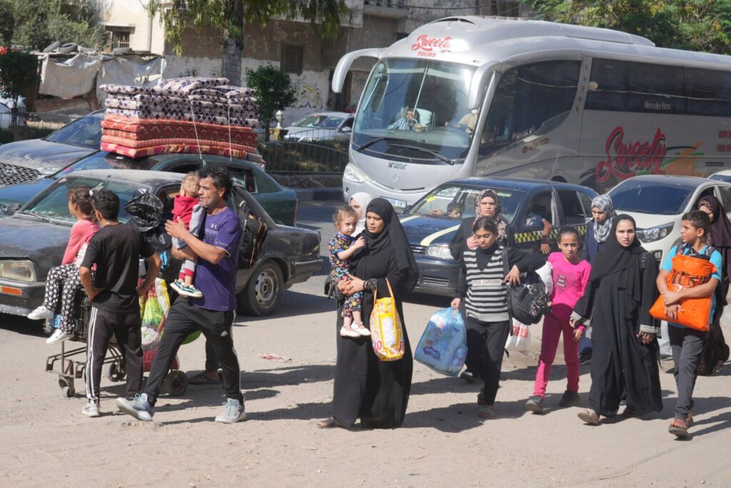 Palestinians flee to the southern Gaza Strip after the Israeli army issued an evacuation warning to a population of over 1 million in northern Gaza and Gaza City to seek refuge in the south ahead of a possible Israeli ground invasion, Friday, October 13, 2023. (AP Photo/Hatem Moussa)