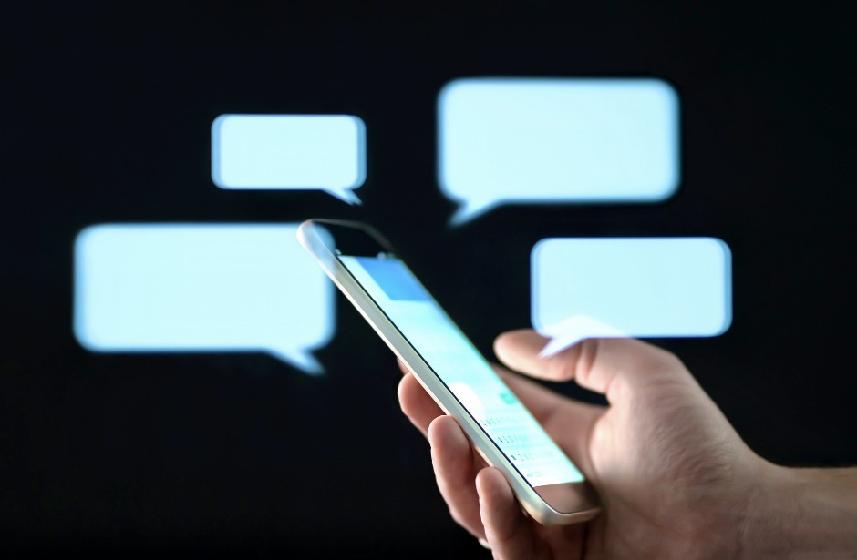Motor taxi firm to be asked to address 'illicit sexual bookings' -- dad. Text messages in cellphone screen with abstract hologram speech bubbles. 
