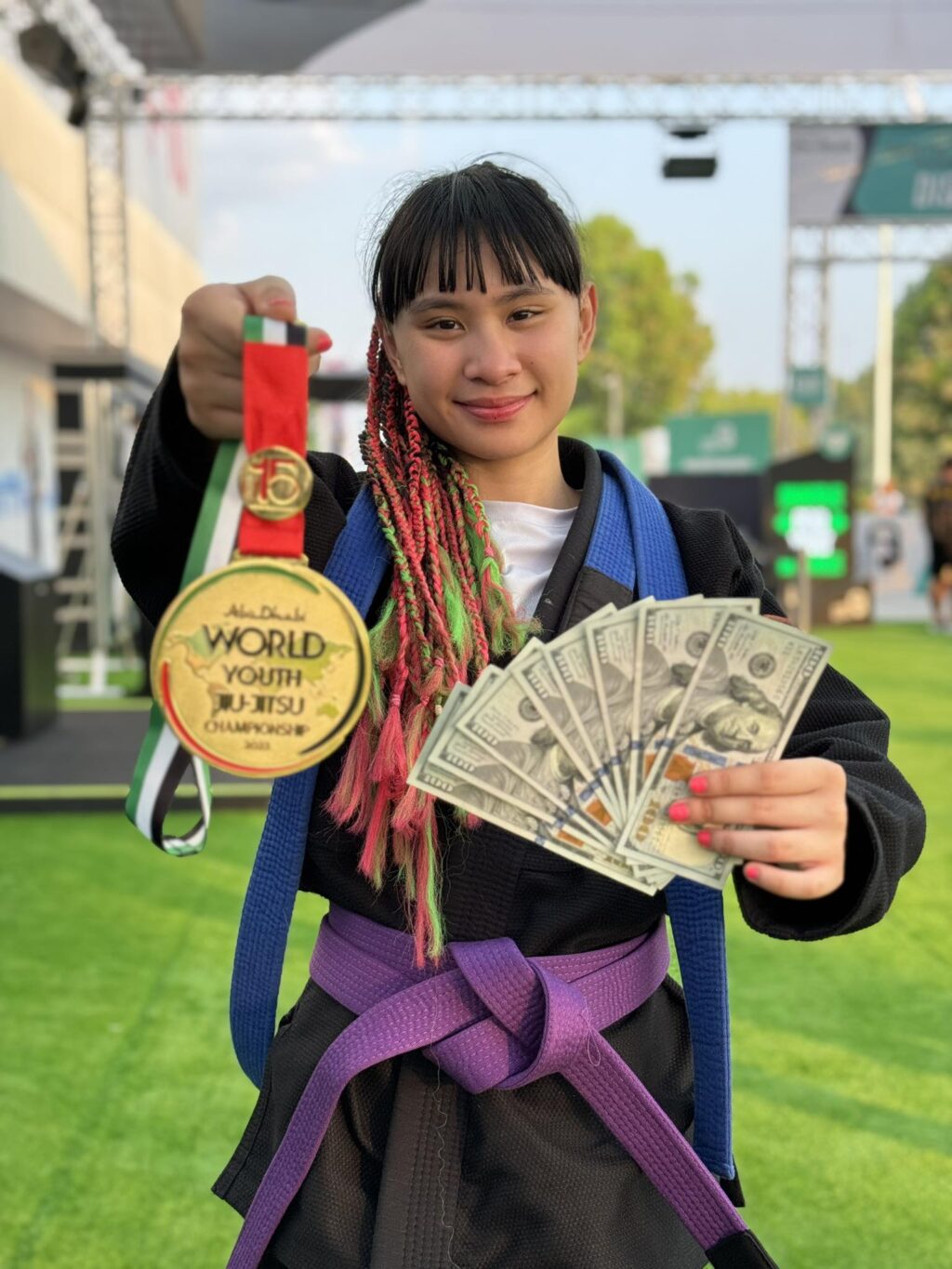 Ellise Xoe Malilay proudly shows her gold medal and cash prize she earned for topping her category in the Abu Dhabi World Youth Jiu-Jitsu Championships in Abu Dhabi, UAE.