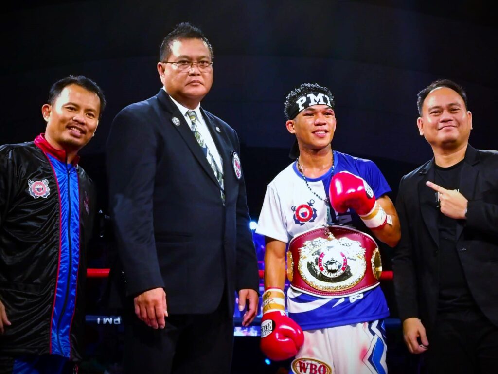 Regie Suganob (second from right) wears the WBO Global light flyweight belt around his waist. He is joined by veteran matchmaker and trainer Edito Villamor (leftmost), WBO Asia Pacific VP Leon Panoncillo (2nd from left) and PMI Bohol Boxing Promotions manager and promoter Floriezyl Echavez Podot (rightmost).