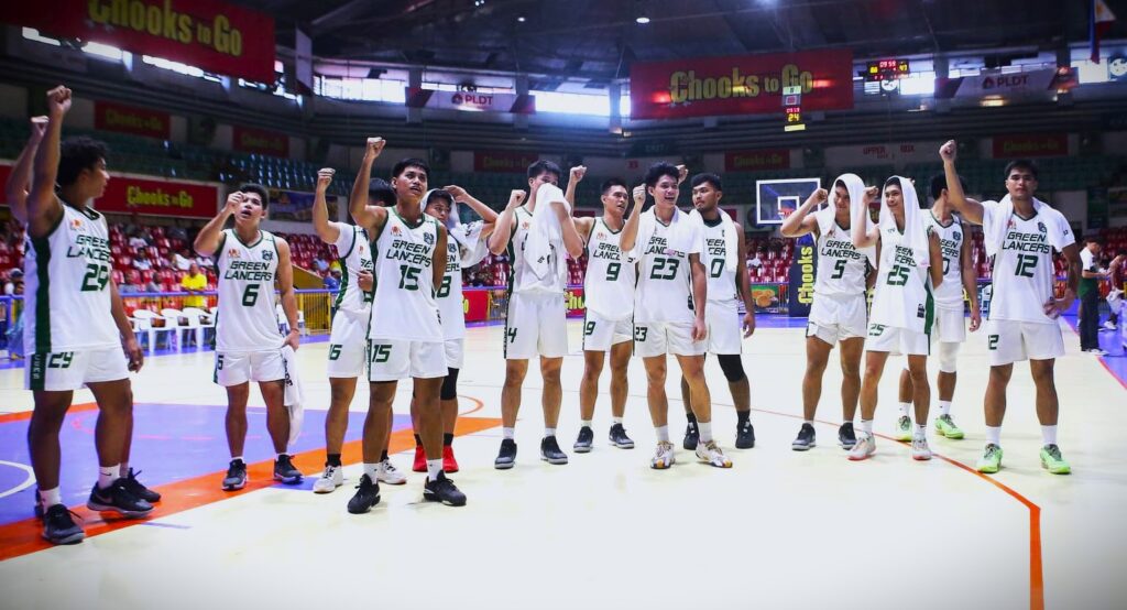 UV Green Lancers players raise their clinched fist while singing their school hymn during their Cesafi men's basketball game vs. the SWU-Phinma Cobras.