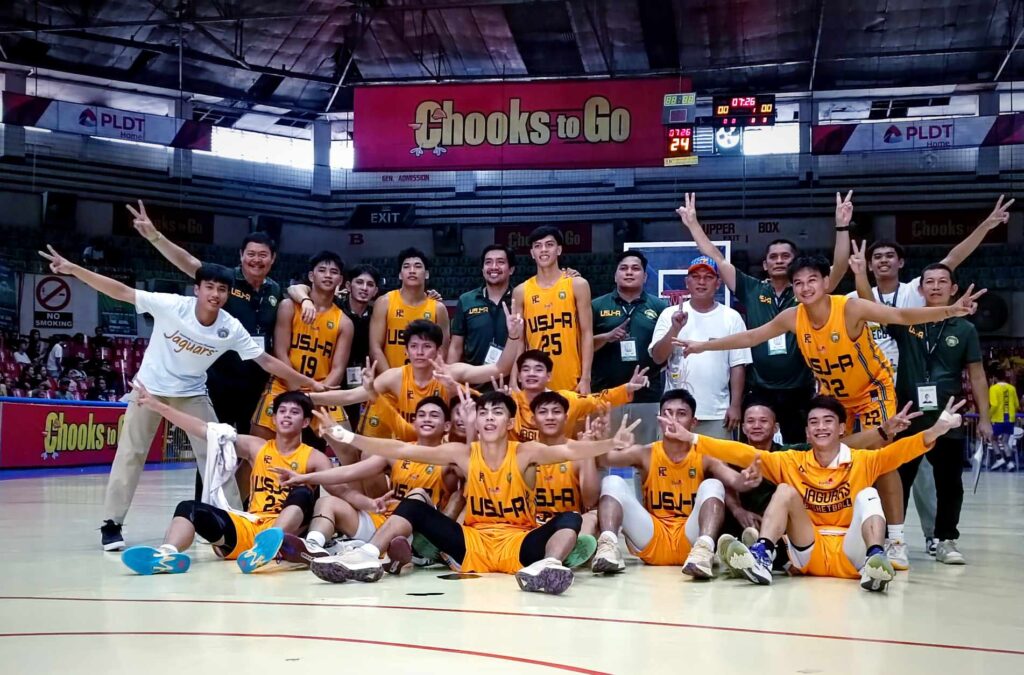 The USJ-R Baby Jaguars players and coaching officials pose for a group photo after clinching the top spot of the Cesafi high school basketball.