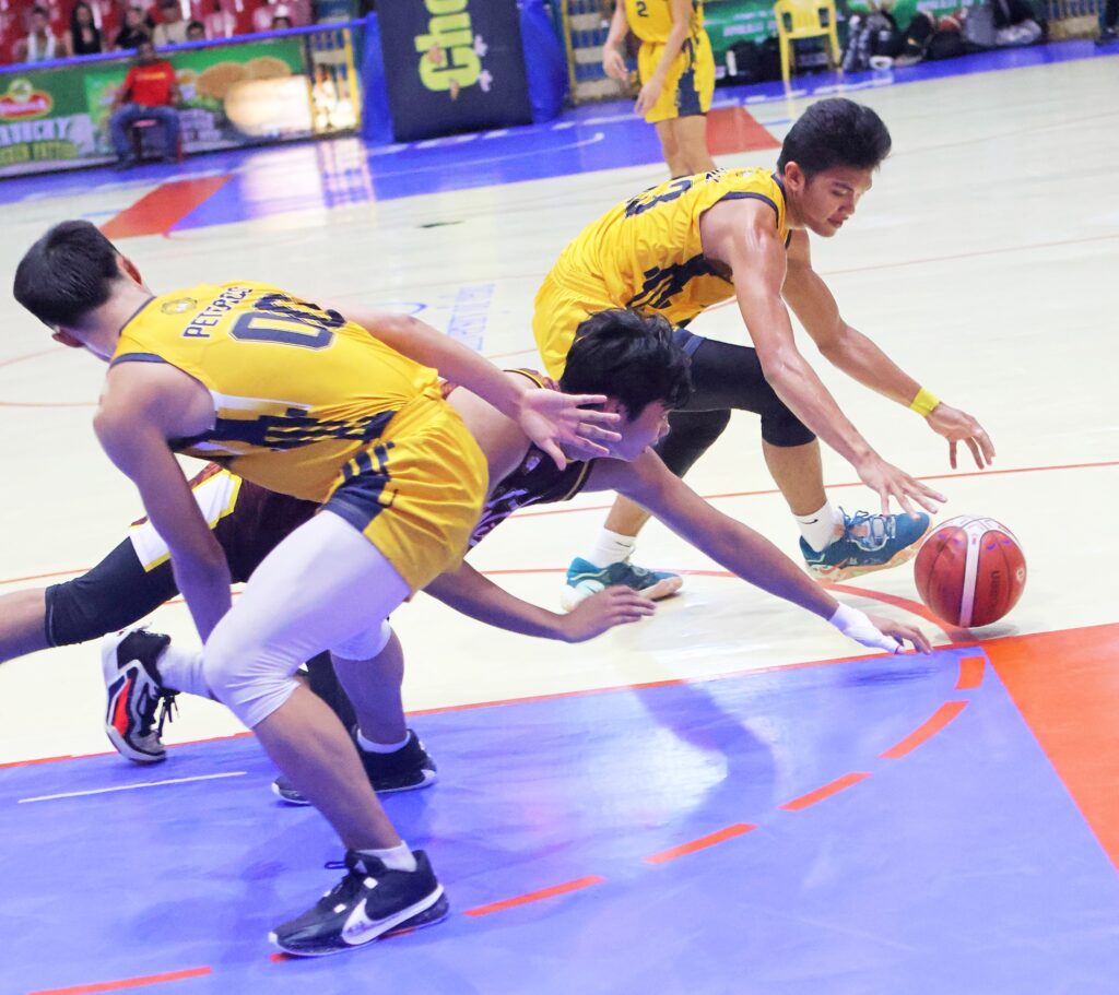 USPF Panthers eye more wins to tighten hold on No. 3 spot of Cesafi men’s hoops rankings. In photo is Peter John Peteros and Andre Cuizon of USPF (yellow jerseys) scramble to secure a loose ball against CIT-U's Joie Villamayor in Cesafi's men's basketball tournament. | Photo from Sugbuanong Kodaker