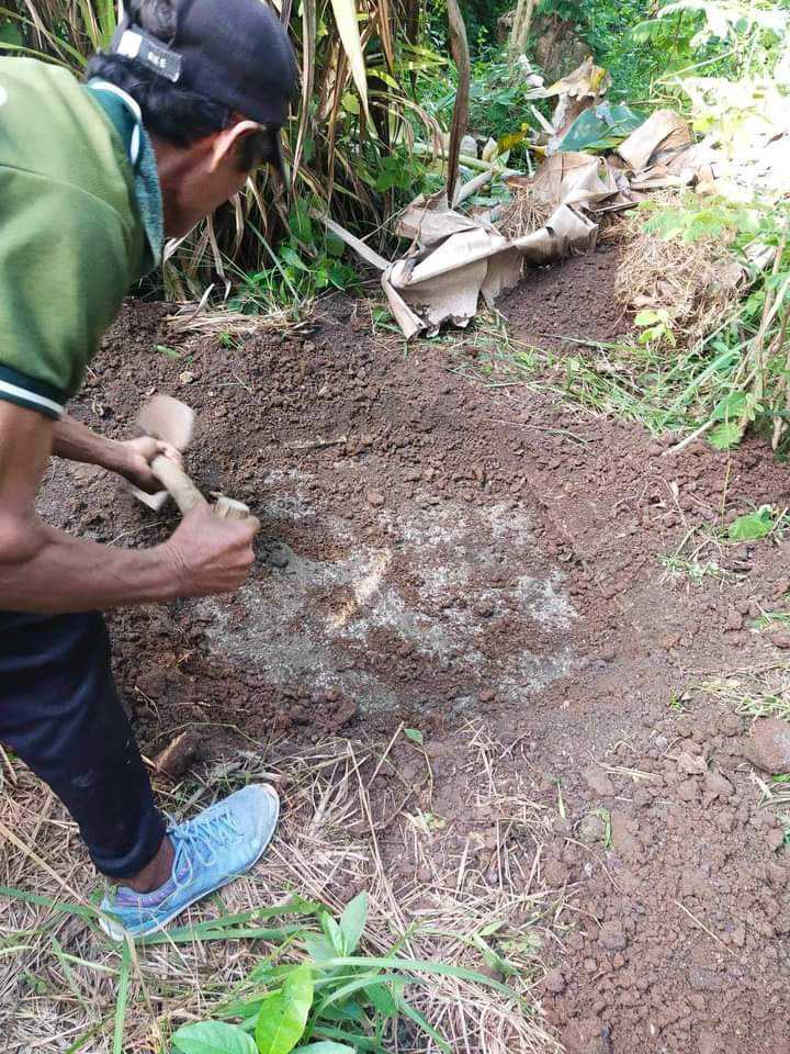 Hard blow to the head killed caretaker, who was found dead inside toilet hole in Camotes town. In photo is one of the search party as he digs to open the sealed traditional toilet hole where the victim's body was found last November 3.| Contributed photo