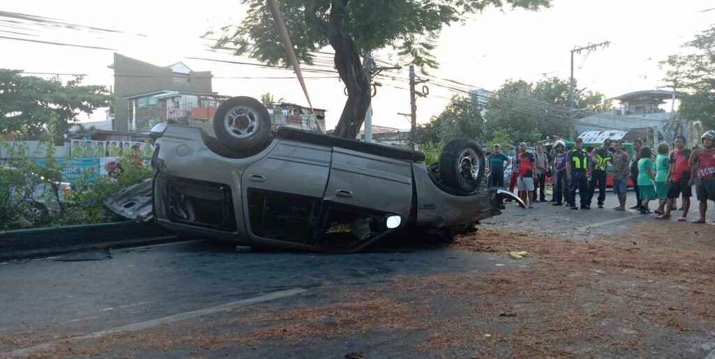 Korean national flees after bumping truck, ends up in multiple-vehicle collision that killed rider. In photo is the SUV driven by the Korean which is overturned after being involved in a multiple-vehicle collision resulting to the death of a motorcycle rider. | Paul Lauro