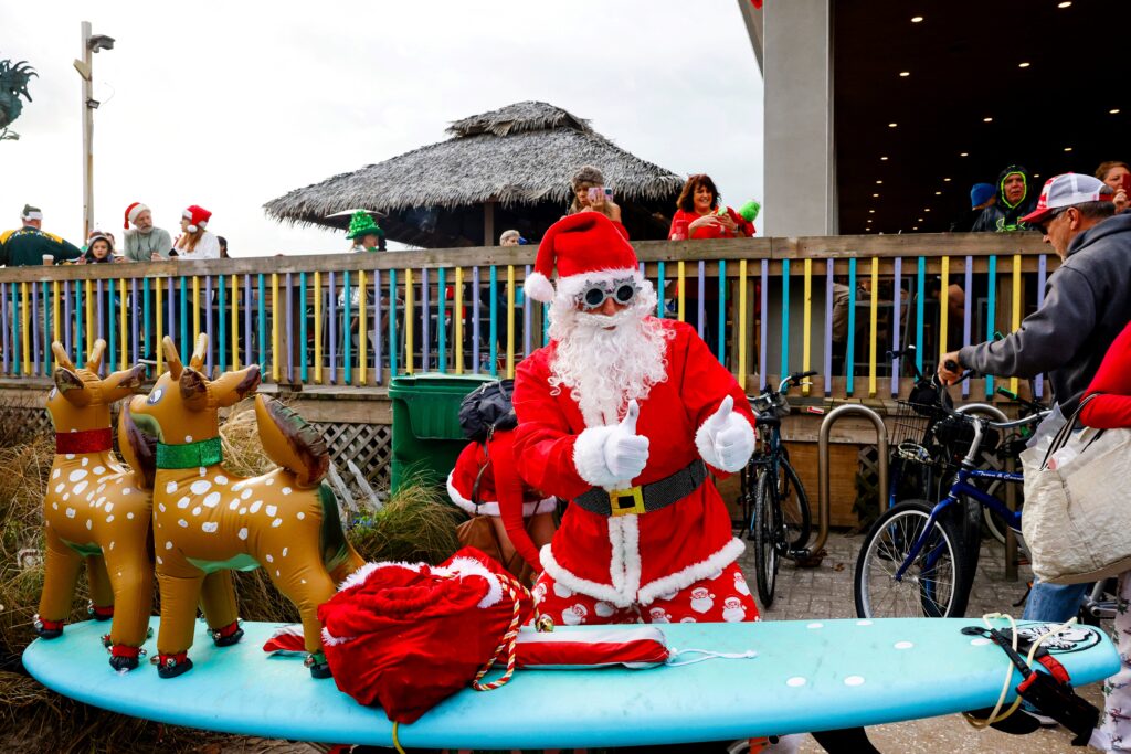Surfing Santa ride waves in Florida. A surfer dressed as Santa poses during the 15th annual Surfing Santas event in Cocoa Beach, Florida, on December 24, 2023. (Photo by Eva Marie UZCATEGUI / AFP)