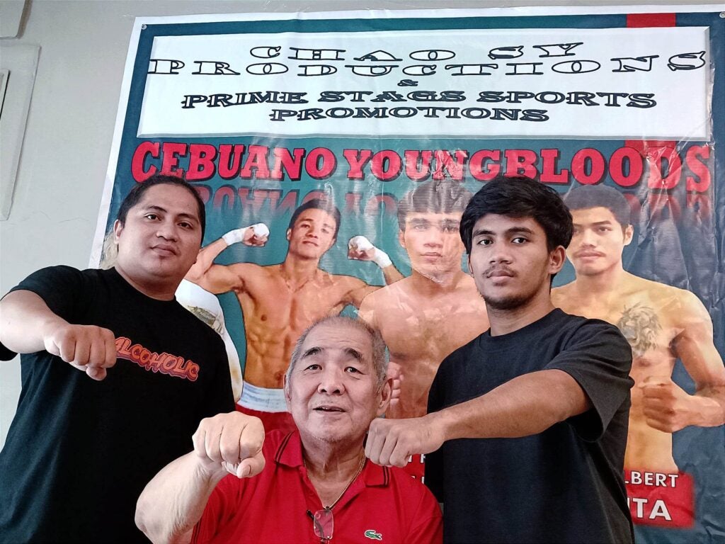 (L-R) Boxing trainer Junrel Jimenez, boxing promoter Lorenzo "Chao" Sy, and boxing prospect John Kevin Jimenez during a presser in the latter's bout last June.