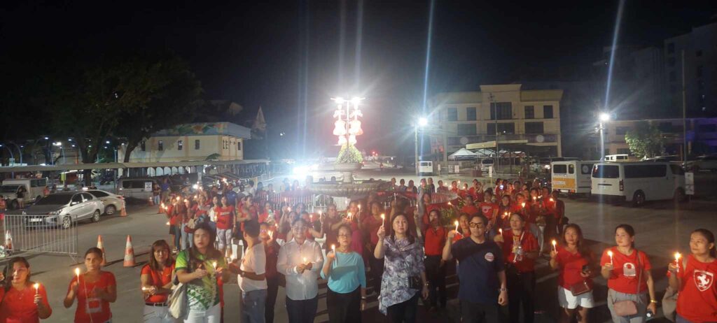 Lapu-Lapu City officials led by Mayor Junard Chan joins a candle-lighting activity on Friday, Dec. 8, in celebration of World Aids Day.