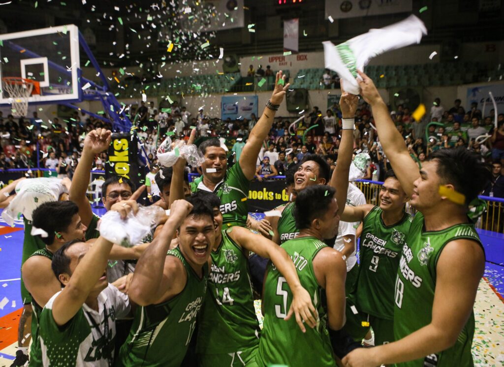 Gary Cortes, UV Green Lancers head coach, is being carried by his players after winning the Cesafi Season 22 men's basketball title.