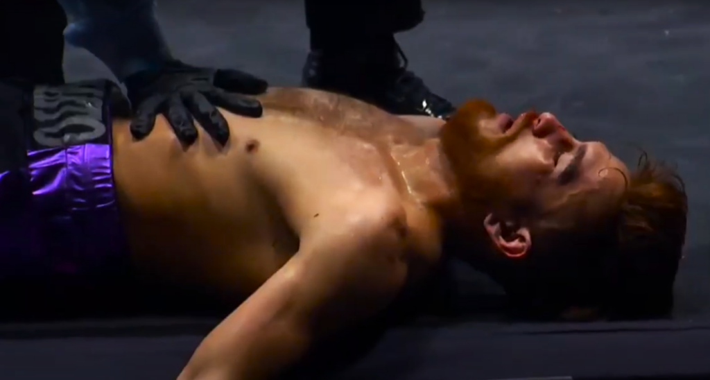 Isaac Avelar lying on the canvas after being knocked out by Mark Magsayo.