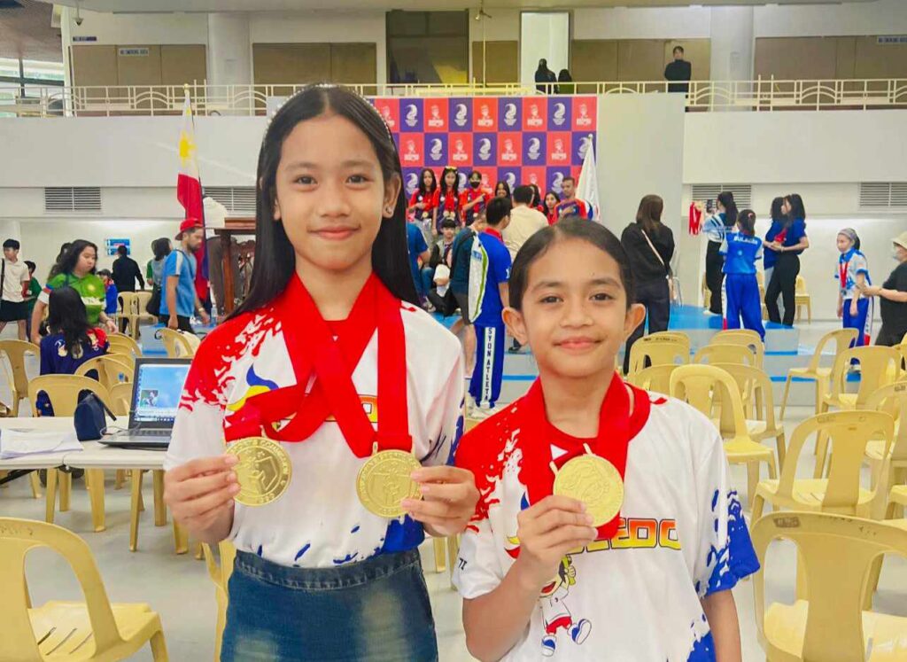 Apple and Dona Jane Rubin proudly showing the gold medals they won for Toledo City in the Batang Pinoy National Championships.