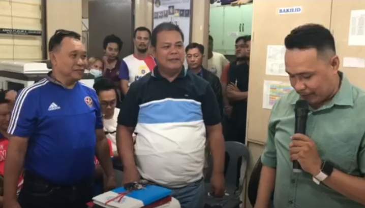 Maguikay Brgy. Captain Eduardo  Gumera Sr. (middle) was proclaimed winner of the last Oct. 30 BSKE elections by the Barangay Board of Canvassers headed by Maguikay National High School Principal Jomar Caborog (right) on Wednesday afternoon.