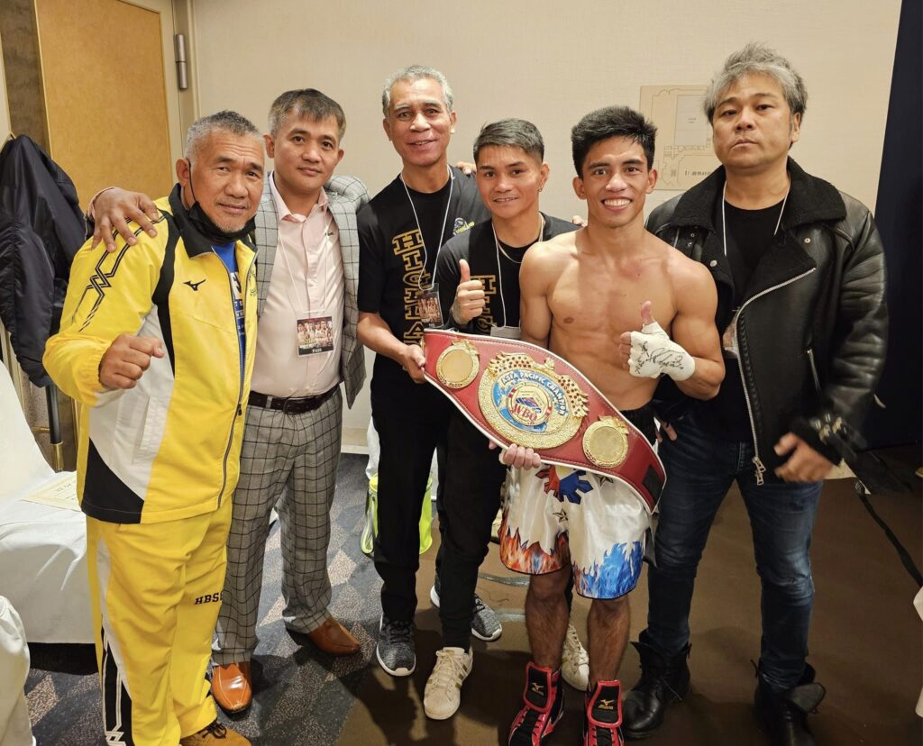 Jayson Vayson holding his WBO Asia Pacific light flyweight belt along with his manager and trainers. | Photo from Brico Santig's Facebook page