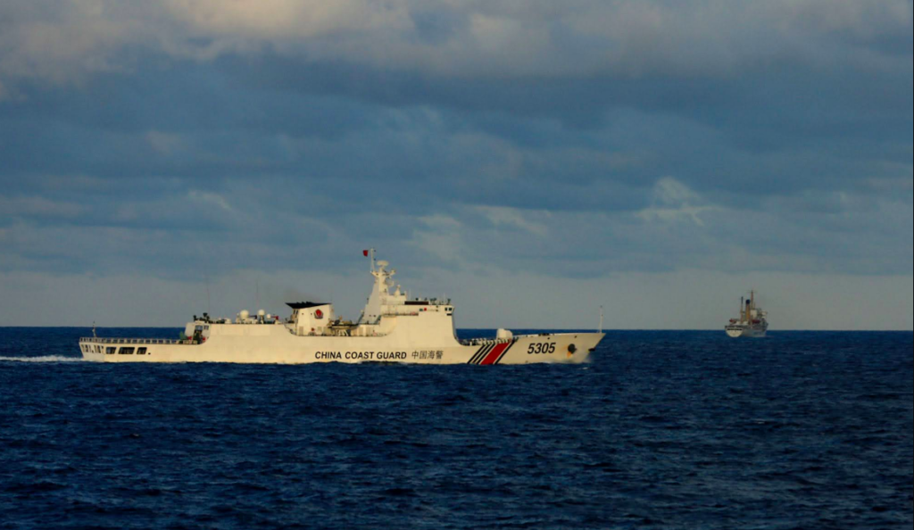 WPS: More PH boats harassed by Chinese vessels; civilian convoy aborts Christmas run. RETREAT | This photo taken from a Philippine Coast Guard ship shows Kapitan Oca, the main vessel of the “Atin Ito” Coalition’s convoy, making a turnaround in the distance while being watched by a China Coast Guard ship at South of Kayumanggi Bank in the West Philippine Sea. (Photo by RICHARD A. REYES / Philippine Daily Inquirer)
