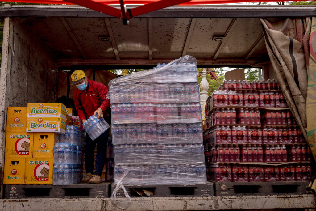 Bottled water contains hundreds of thousands of plastic bits — study. In this picture taken on October 28, 2023 a worker stacks crates of bottled water on the back of a truck in Vientiane. (Photo by Jack TAYLOR / AFP)