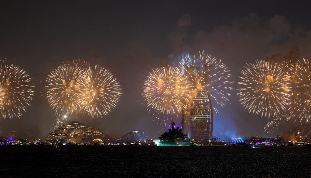 World rings in 2024 after war, bots and Barbie. Fireworks light up the sky by the landmark Burj al-Arab luxury hotel tower in Dubai at midnight on new year's eve on January 1, 2024. (Photo by Giuseppe CACACE / AFP)