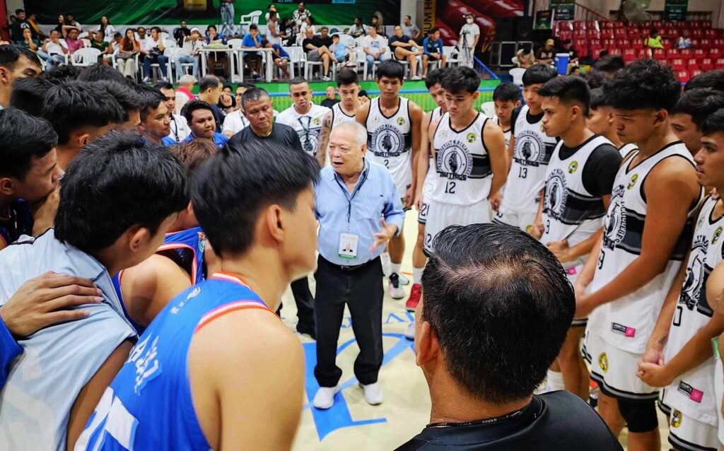 Commissioner Felix Tiukinhoy Jr. (middle) speaks to players during one of Cesafi men's basketball tournament games at the Cebu Coliseum. 