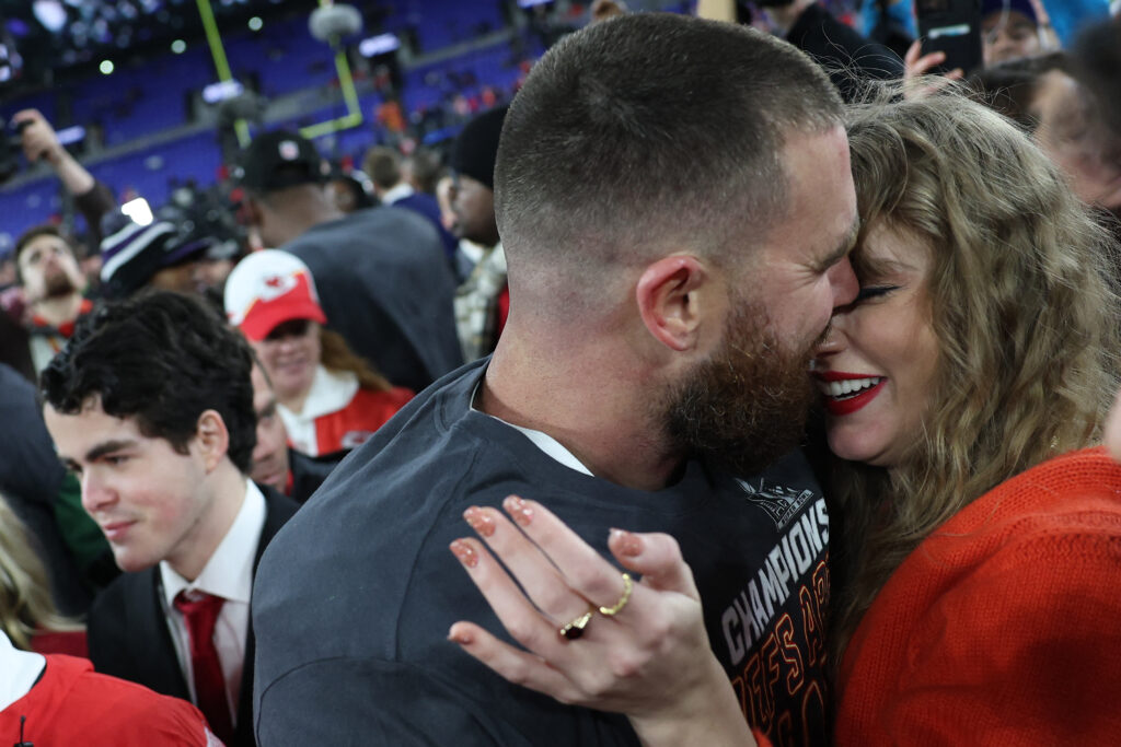 Taylor Swift greets Super Bowl-bound Travis Kelce with a kiss after Chiefs win the AFC title game. Travis Kelce #87 of the Kansas City Chiefs embraces Taylor Swift after a 17-10 victory against the Baltimore Ravens in the AFC Championship Game at M and T Bank Stadium on January 28, 2024 in Baltimore, Maryland. | Patrick Smith/Getty Images/AFP