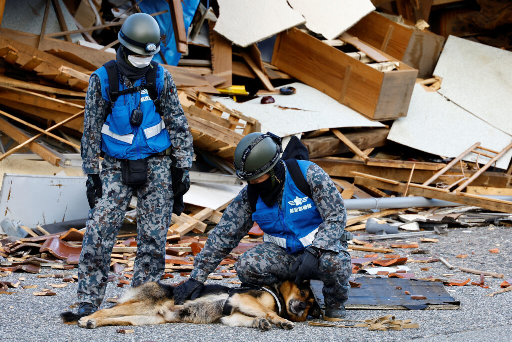 Japan quake update: Woman in her 90s rescued alive 5 days under collapsed house. In photo is a member of Japan Air Self-Defense Force petthing a military dog during a search for survivors at the site of collapsed buildings, in the aftermath of an earthquake, in Wajima, Ishikawa Prefecture, Japan, January 5, 2024. REUTERS/Kim Kyung-Hoon