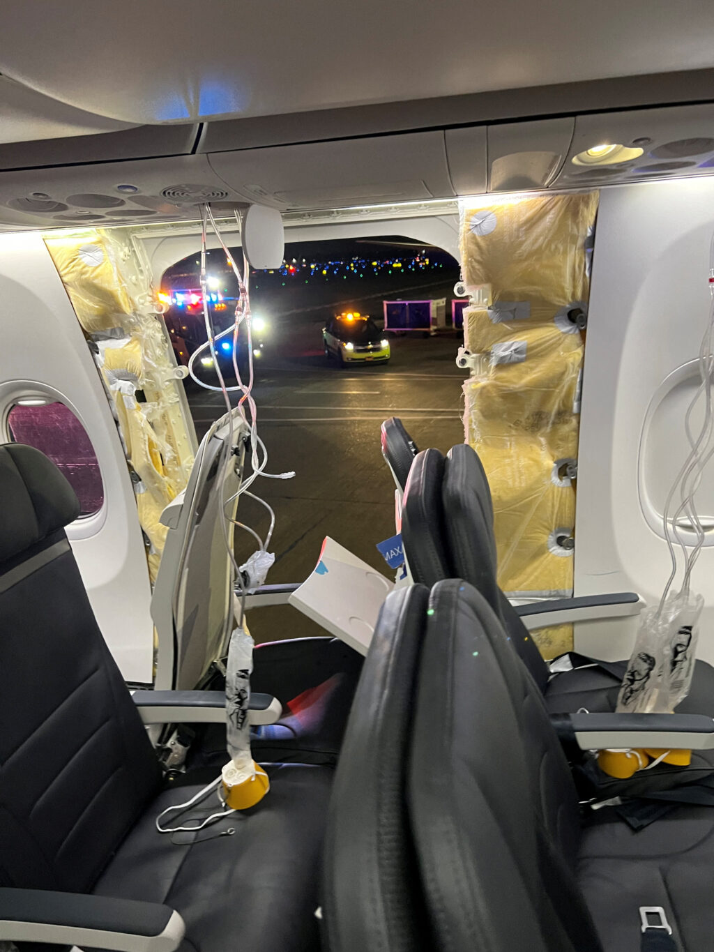 Boeing 737 Max 9 jetliners grounded after Alaska Airlines plane suffers blowout. In photo are passenger oxygen masks hanging from the roof next to a missing window and a portion of a side wall of an Alaska Airlines Flight 1282, which had been bound for Ontario, California and suffered depressurization soon after departing, in Portland, Oregon, U.S., January 5, 2024 in this picture obtained from social media. Instagram/@strawberrvy via REUTERS