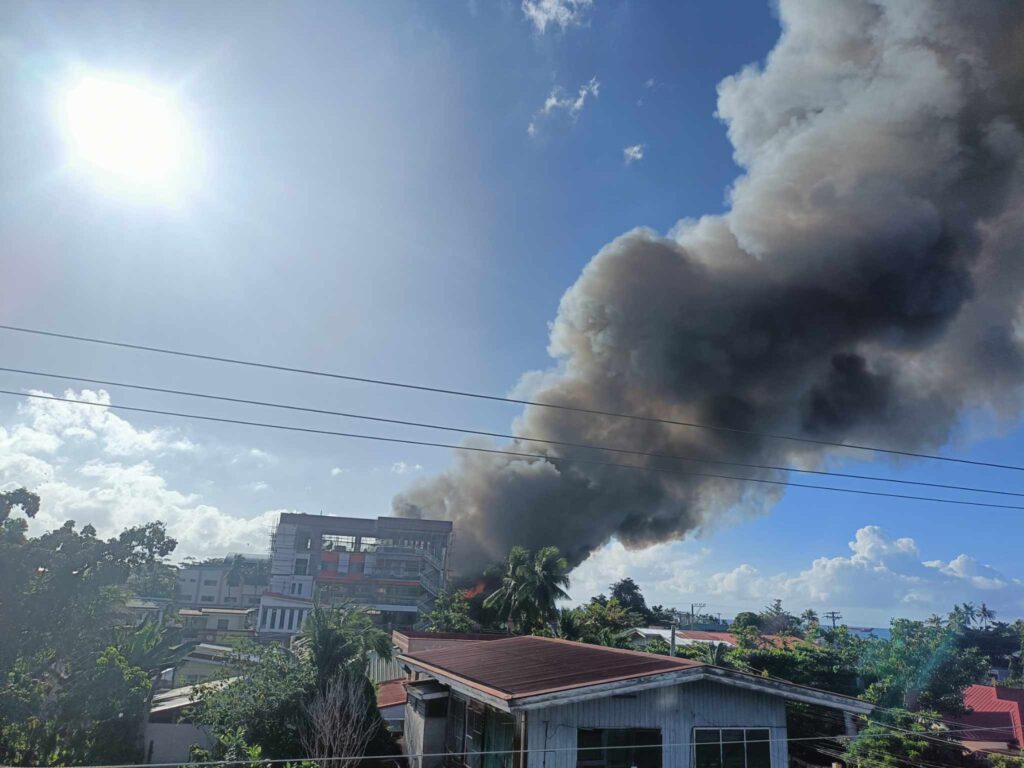 Thick smoke is seen as fire burns homes in Barangay Poblacion, Talisay City on Wednesday morning.