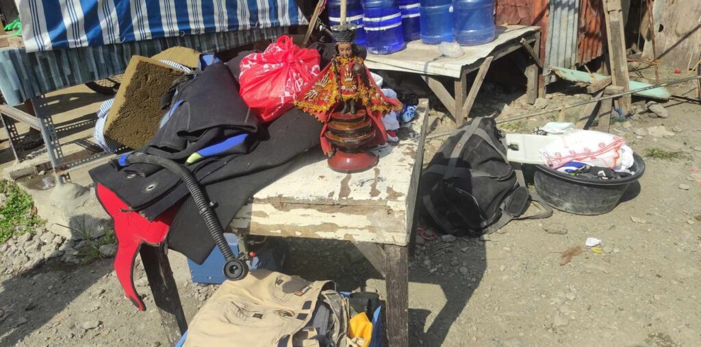 An image of the Señor Sto. Niño is seen among the belongings of some of the residents that they salvaged as the fire rages in Barangay Poblacion, Talisay City this morning, January 24. | Contributed photo via Paul Lauro