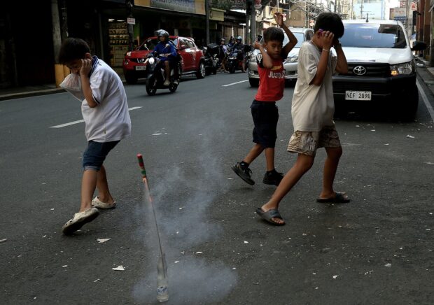 Baby, youngest case of FWRI. BRING IN THE NOISE Children light firecrackers at Juan Luna Street in Manila on New Year’s Eve. —RICHARD A. REYES