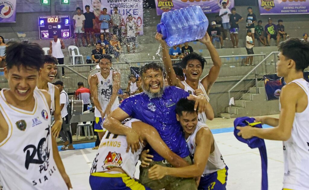 The UC Baby Webmasters celebrate after winning the BPBL Season 2 Central Visayas finals 18-under title as they pouring water to their head coach Joever Samonte.