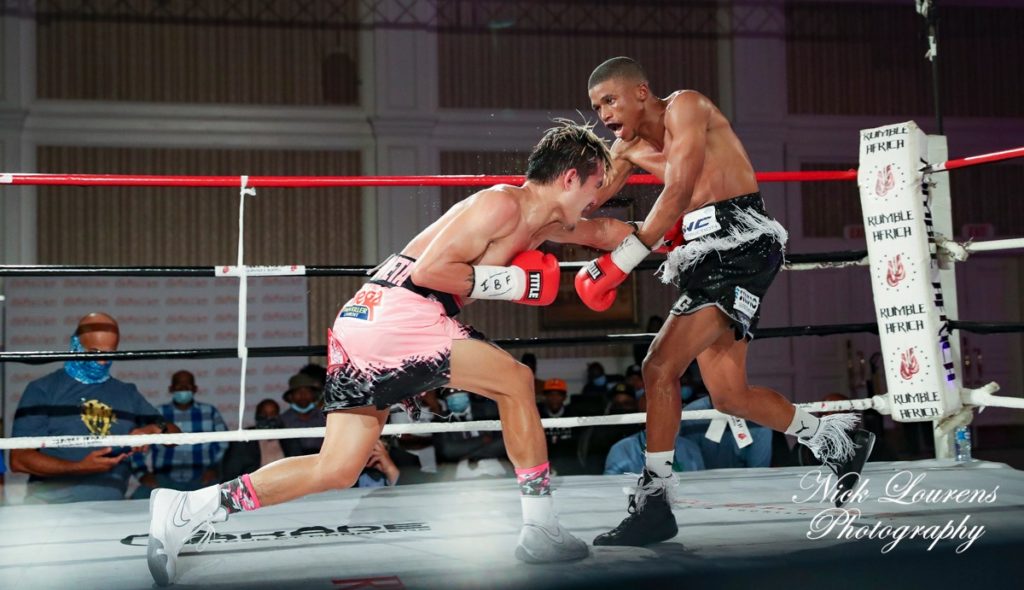 Christian Araneta (wearing pink trunks) lands a body shot to Sivenathi Nontshinga during their world title eliminator showdown last April 25, 2021 in South Africa.