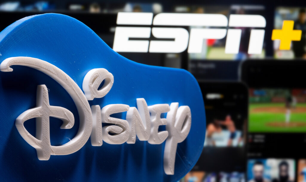 A 3D printed Disney logo is seen in front of the ESPN+ logo in this illustration taken on July 13, 2021. REUTERS/Dado Ruvic/Illustration