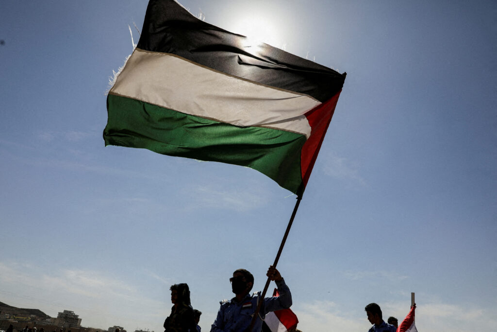 Houthi rebels set ship ablaze. In photo are Houti rebel supporters waving a Palesinian flag.| Reuters [FILE PHOTO]