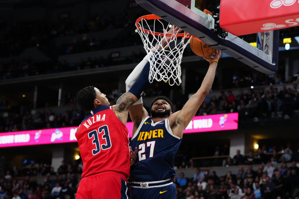 NBA: Denver Nuggets guard Jamal Murray (27) shoots over Washington Wizards forward Kyle Kuzma (33) in the first quarter at Ball Arena. / Ron Chenoy-USA TODAY Sports