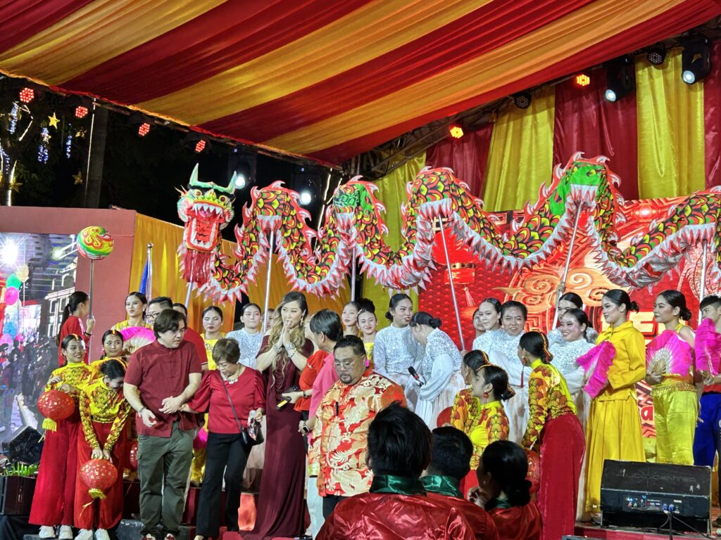 performers during the red lantern festival gathered on stage together with a dragon mascot