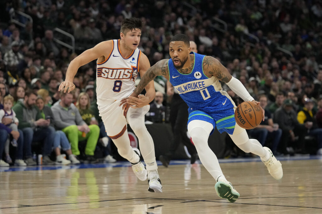NBA: Bucks without Giannis stun Suns with help from Lillard's 31 points. Damian Lillard #0 of the Milwaukee Bucks dribbles the ball against Grayson Allen #8 of the Phoenix Suns during the first half at Fiserv Forum on March 17, 2024 in Milwaukee, Wisconsin.  Getty Images via AFP