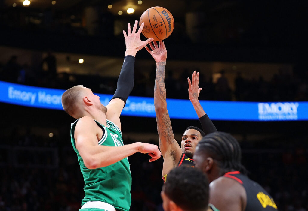 NBA: Hawks hold off Celtics in NBA overtime thriller. Dejounte Murray #5 of the Atlanta Hawks shoots a basket against Kristaps Porzingis #8 of the Boston Celtics during overtime at State Farm Arena on March 28, 2024 in Atlanta, Georgia. | Getty Images via AFP