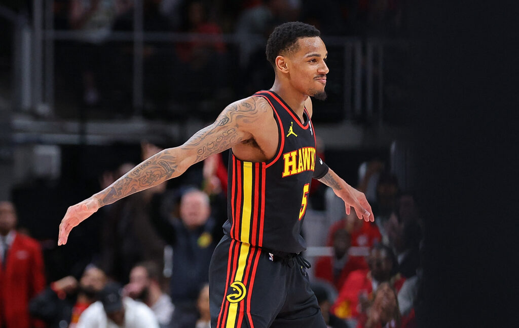 NBA: Hawks hold off Celtics in NBA overtime thriller. Dejounte Murray #5 of the Atlanta Hawks reacts after a three-point basket against the Boston Celtics during overtime at State Farm Arena on March 28, 2024 in Atlanta, Georgia. | Getty Images via AFP