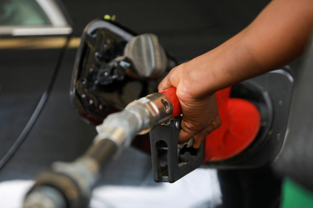 A gas station attendant pumps fuel .