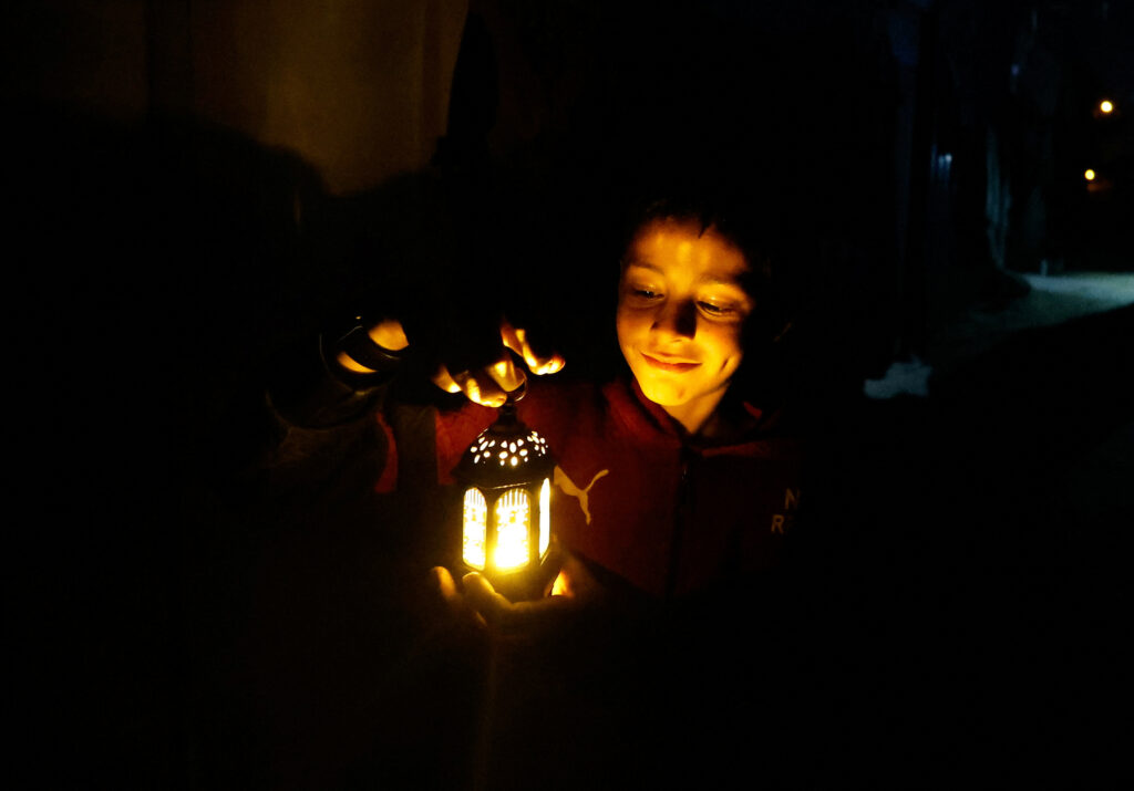 A child holds a lantern as displaced Palestinians prepare their tents for Ramadan, amid the ongoing conflict between Israel and the Palestinian Islamist group Hamas, in Rafah, in the southern Gaza Strip March 9, 2024. REUTERS/Mohammed Salem