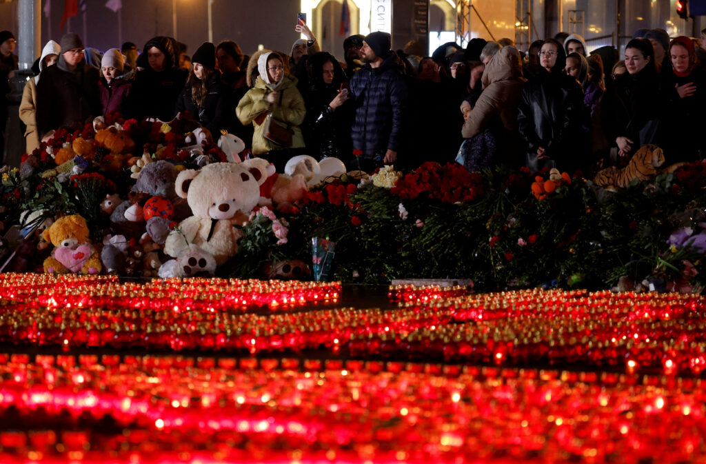 Russia mourns as toll in theatre shooting shoots up to 137. People stand in front of lit candles outside the Crocus City Hall concert venue on the day of mourning declared following a deadly shooting, in the Moscow Region, Russia, March 24, 2024. REUTERS/Maxim Shemetov