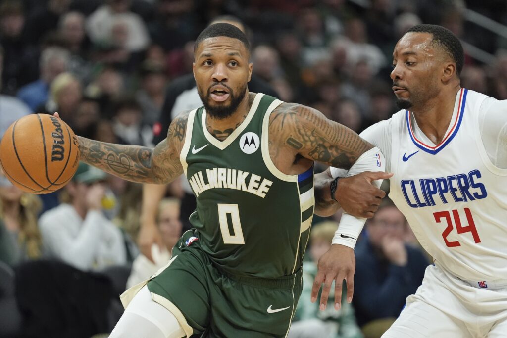 Milwaukee Bucks' Damian Lillard tries to get past Los Angeles Clippers' Norman Powell during the first half of an NBA basketball game Monday, March 4, 2024, in Milwaukee. (AP Photo/Morry Gash)