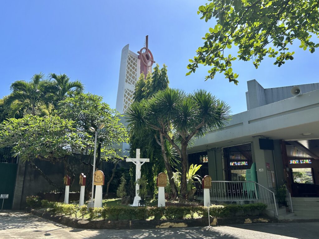 A cross and posts with sculpted images of the Passion of Christ among the gardens in the side are seen at the Adoration Convent of Divine Peace Chapel. | Emmariel Ares