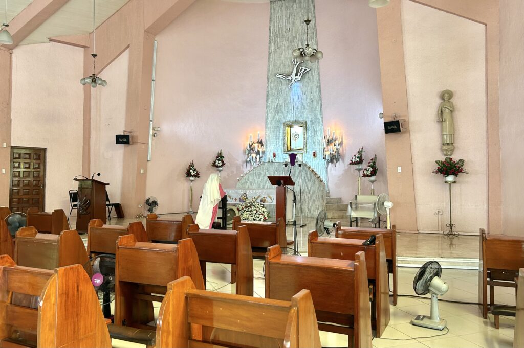Visita Iglesia 2024: Pink Sisters Chapel Adoration Convent of Divine Peace Chapel Holy Week 2024. A Pink Sister nun is seen praying at the area of the altar set up for them. 