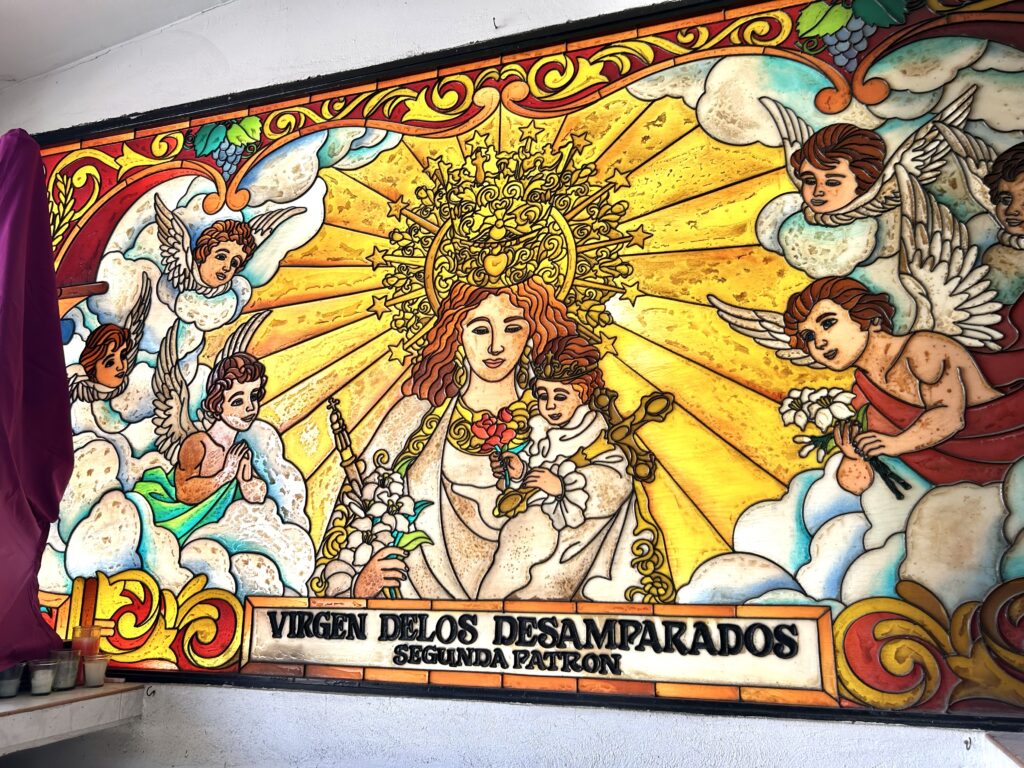 Visita Iglesia 2024: San Isidro Labrador Parish Holy Week 2024. This is a stained glass wall depicting the Our Lady of the Forsaken inside the church. | Emmariel Ares